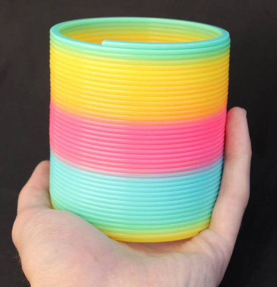 Opaque Rainbow Original HyperSpring, held in Slinky Josh&