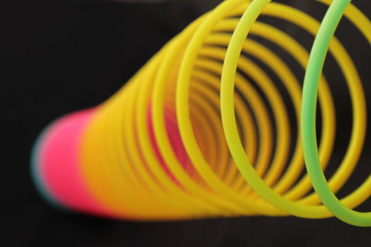 Original HyperSpring Opaque Rainbow in stretched position on black background, close up view