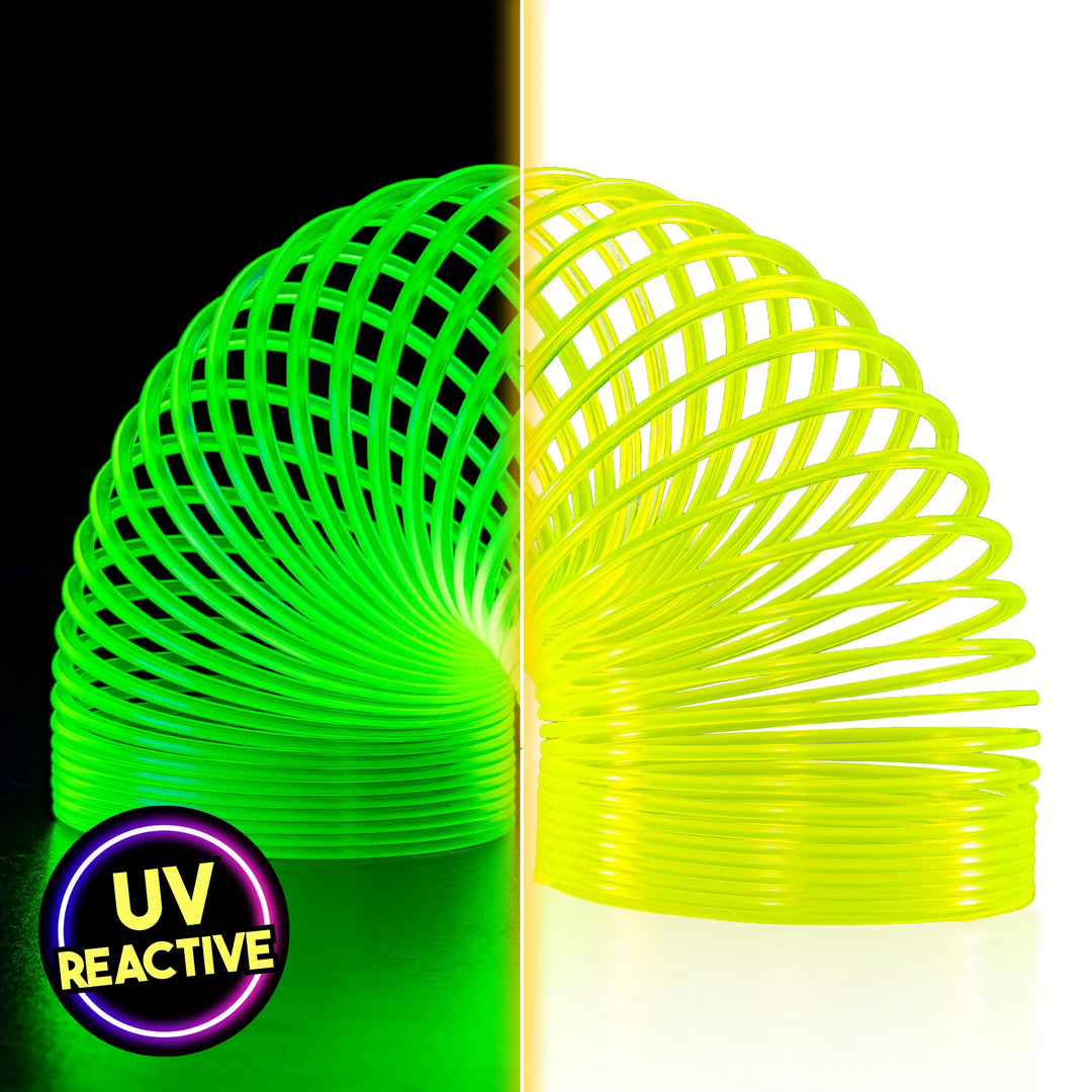 A split-screen product image showcasing The Original HyperSpring™ (3.4") Radioactive Yellow. The left side, under blacklight, shows the spring glowing as a vibrant neon green. The right side shows the spring under normal light, appearing as a bright, radioactive yellow in Rainbow position. A "UV Reactive" badge is visible in the bottom corner.