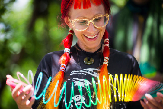 A beautiful young woman with vibrant red hair smiles at her HyperSpring as she tries it for the first time.