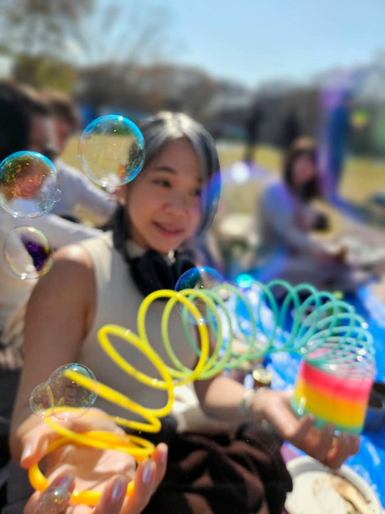Woman using an Opaque Rainbow HyperSpring outdoors with bubbles in the foreground