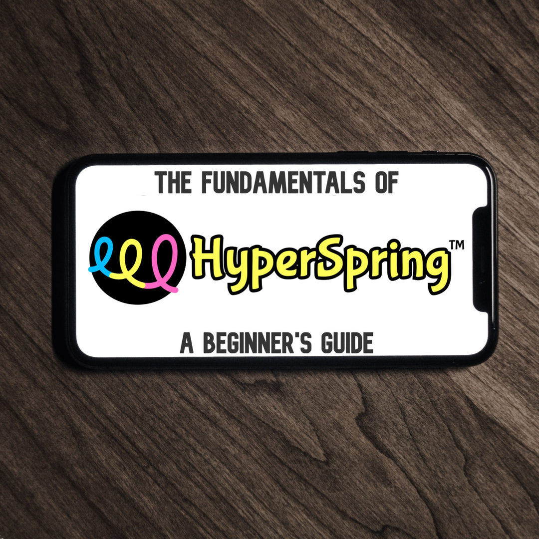 Smart phone lying on table, showing "The Fundamentals of HyperSpring: A Beginner&